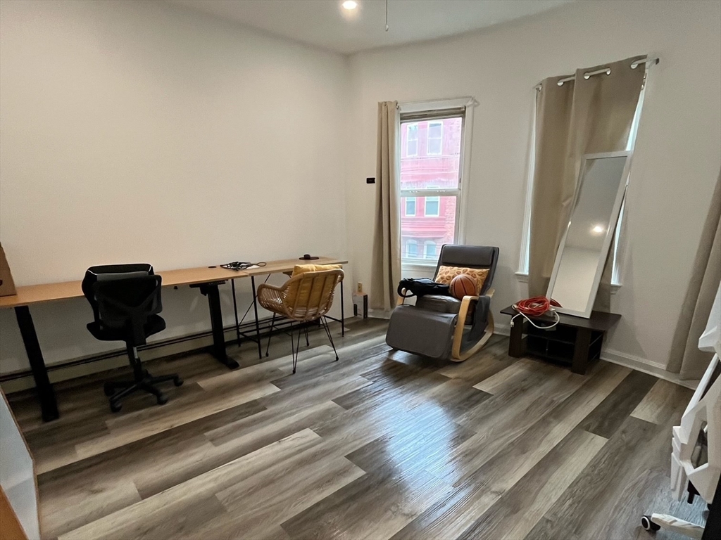 22 Marcella Street, Unit 2 Cambridge, MA 02141 - Photo 4 of 9 a living room with furniture and a wooden floor