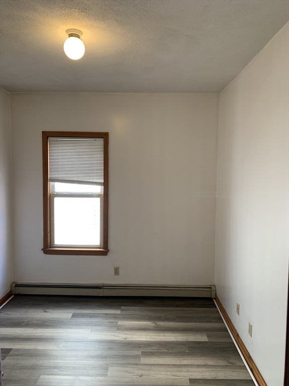 22 Marcella Street, Unit 2 Cambridge, MA 02141 - Photo 7 of 9 a view of a small space with wooden floor and a window