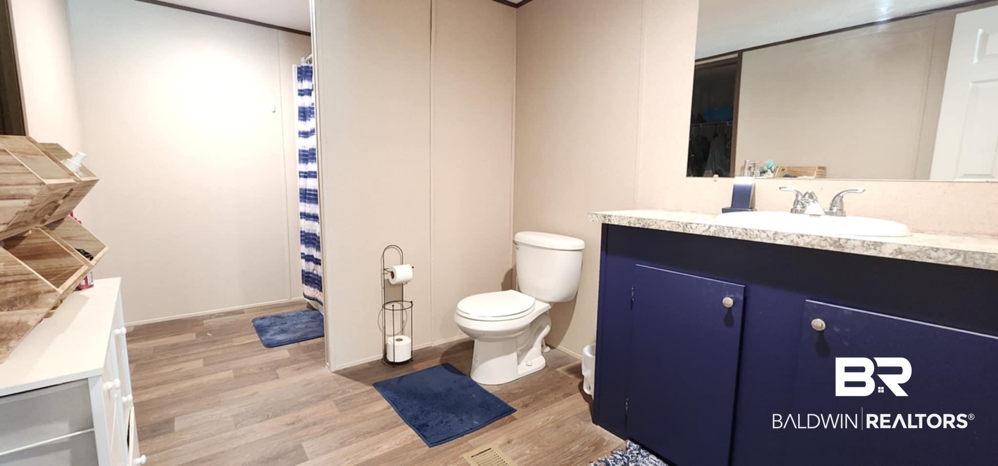 25474 Waterworld Road Robertsdale, AL 36567 - Photo 19 of 30 Full bath featuring vanity, light wood-style flooring, and curtained shower