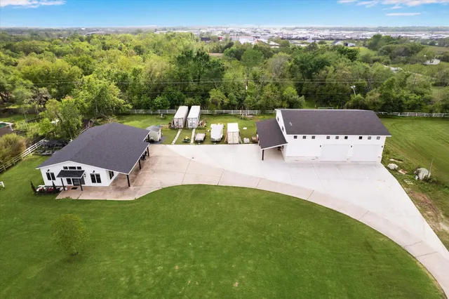 an aerial view of a house with a garden and lake view