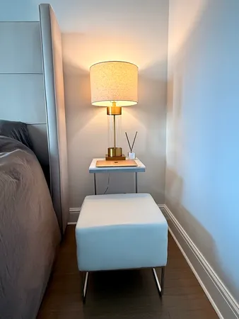 a bedroom with a bed and a lamp