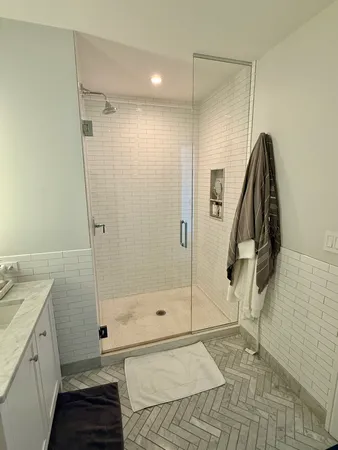 a bathroom with a shower and a sink