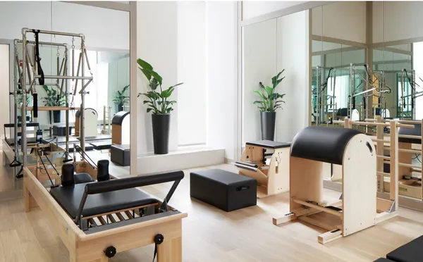 a dining room with furniture a rug and a mirror