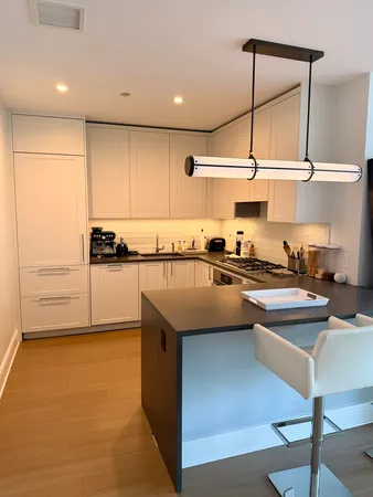a kitchen with kitchen island granite countertop a sink and stove