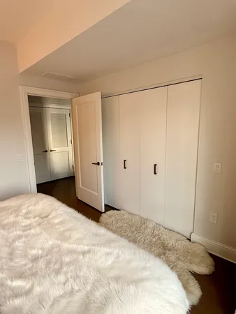 a view of empty room with wooden floor and cabinet