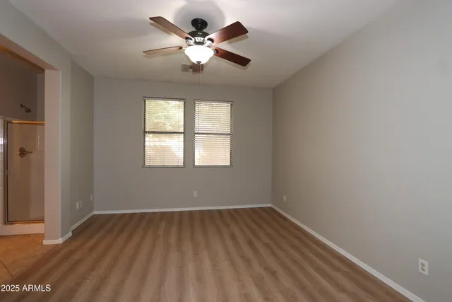 wooden floor in an empty room with a window