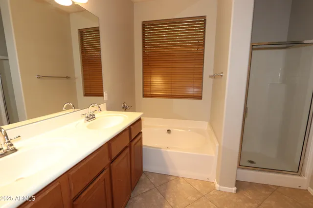 a bathroom with a tub sink and mirror