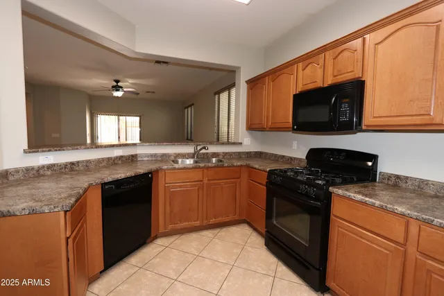 a kitchen with stainless steel appliances granite countertop a sink stove and microwave