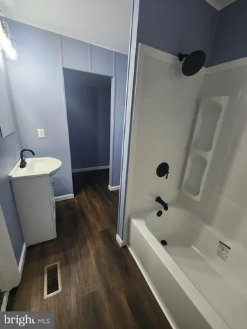 a bathroom with a bathtub sink and toilet
