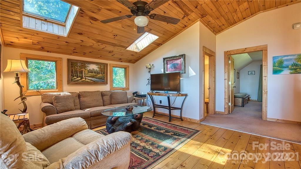 135 Aerial Ridge Waynesville, NC 28785 - Photo 12 of 27 a living room with furniture and a flat screen tv