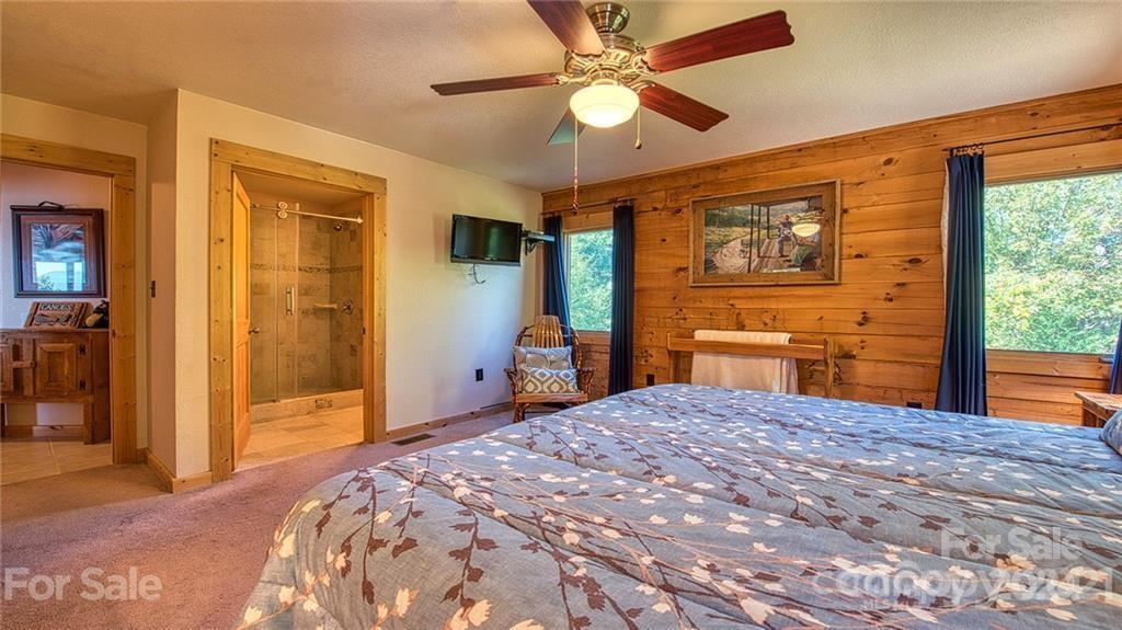 135 Aerial Ridge Waynesville, NC 28785 - Photo 18 of 27 a bedroom with a bed dresser and a window