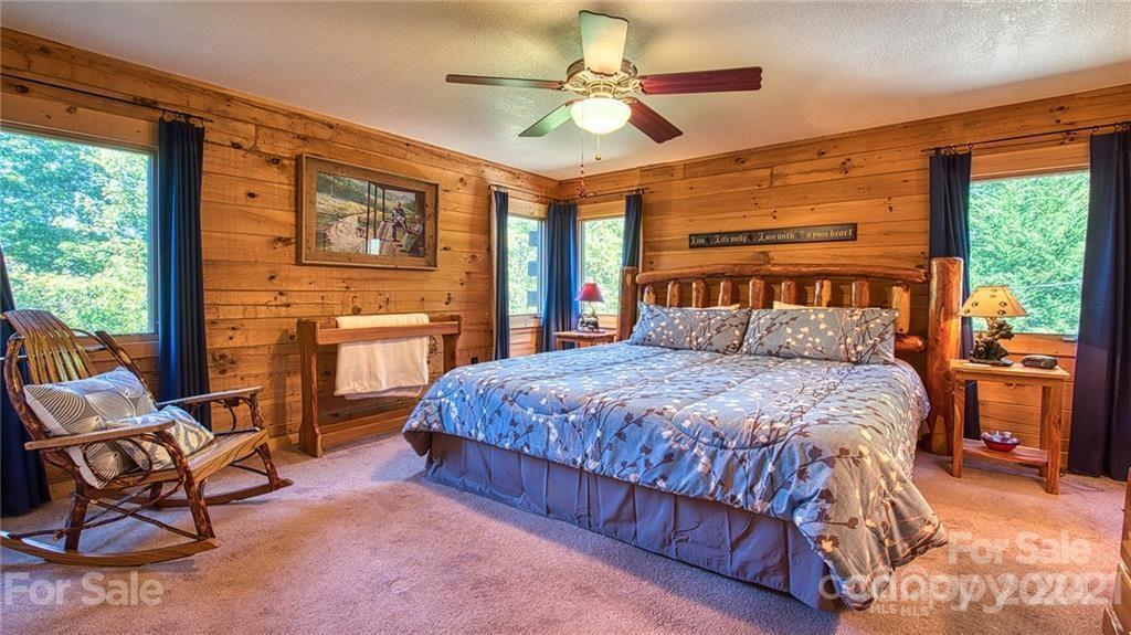 135 Aerial Ridge Waynesville, NC 28785 - Photo 19 of 27 a bedroom with a bed chair and window
