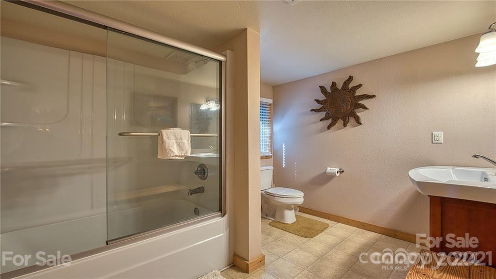 135 Aerial Ridge Waynesville, NC 28785 - Photo 23 of 27 a bathroom with a sink toilet and shower