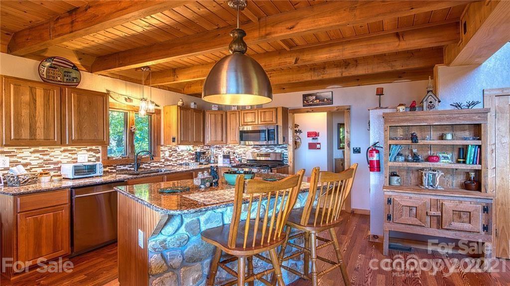 135 Aerial Ridge Waynesville, NC 28785 - Photo 4 of 27 a view of a dining area with furniture and a chandelier