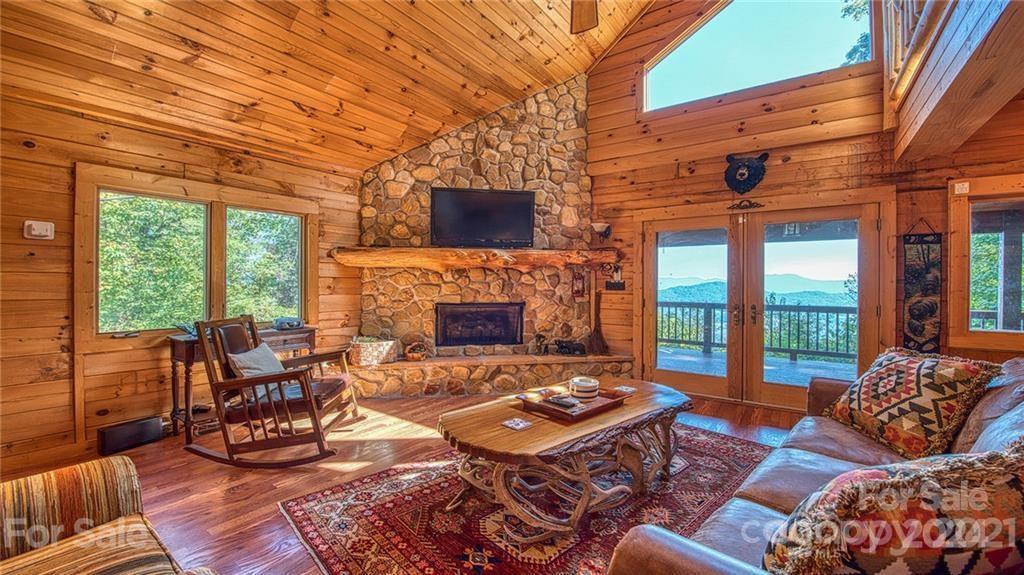 135 Aerial Ridge Waynesville, NC 28785 - Photo 9 of 27 a living room with furniture a fireplace and large windows