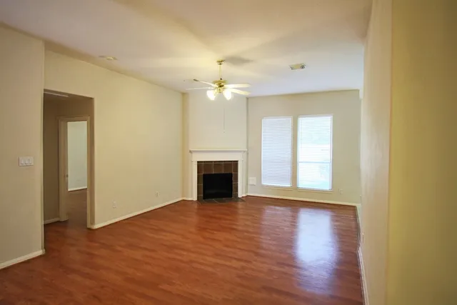 a view of a room window and wooden floor