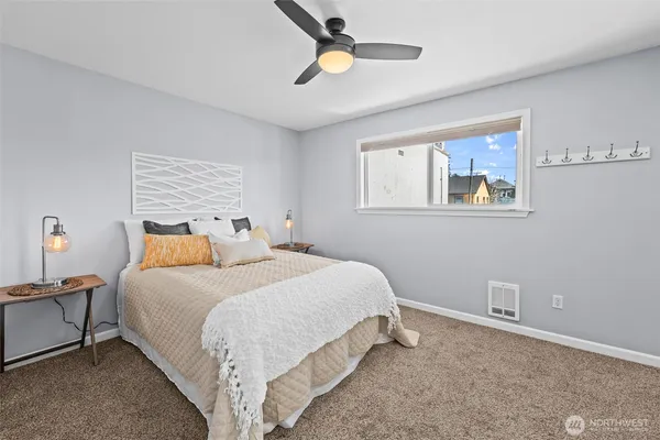 a bedroom with a bed and painting on the wall