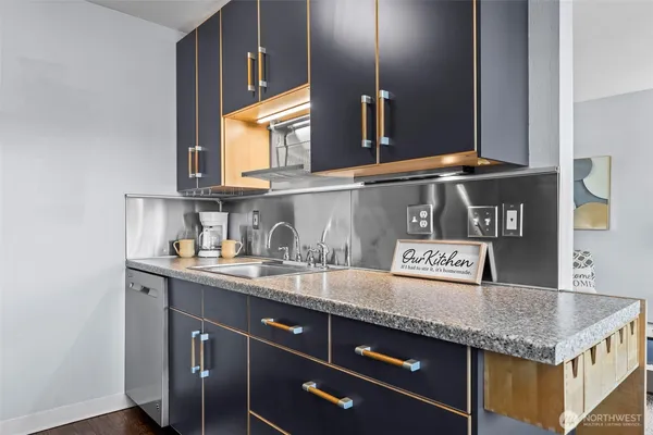a kitchen with granite countertop a sink and cabinets