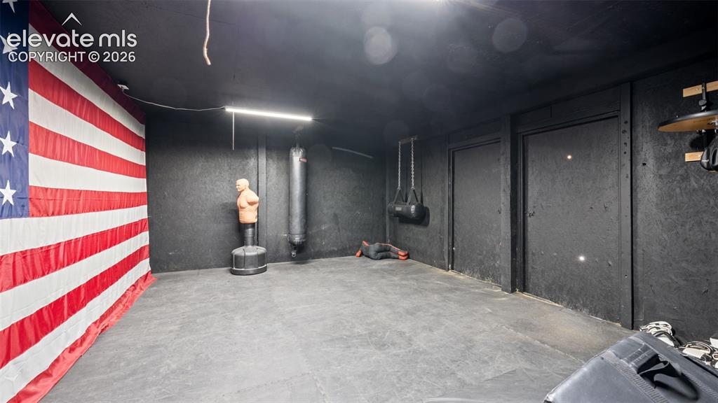 33975 Highway 94 Yoder, CO 80864 - Photo 23 of 40 Finished basement area featuring dark-toned walls, recessed lighting, and durable rubber mat flooring