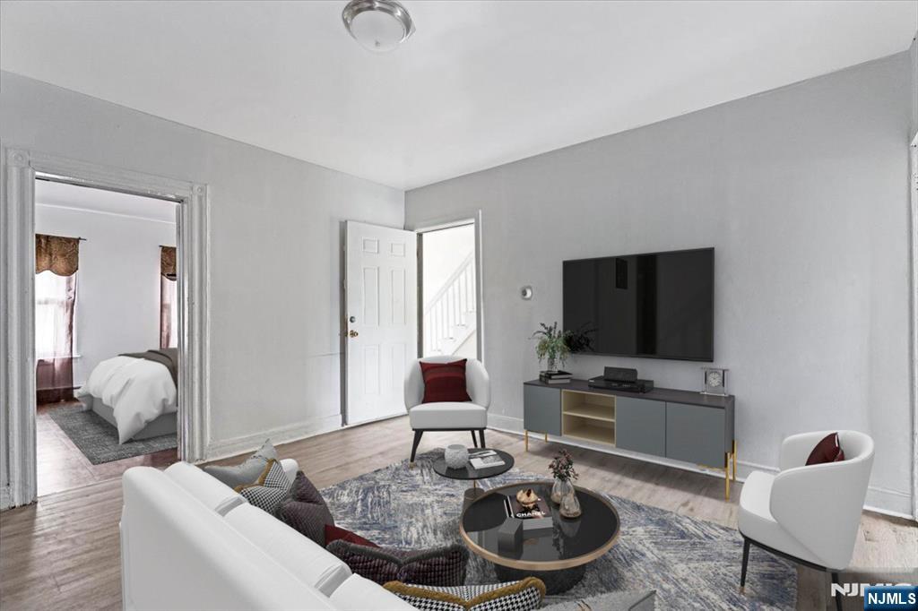 580 Hunterdon Street Newark, NJ 07108 - Photo 2 of 29 a living room with furniture and a flat screen tv