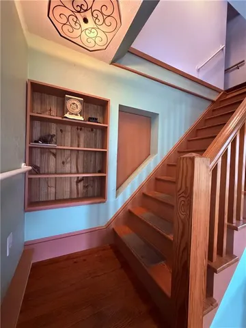 a spacious bedroom with a bed and a chandelier