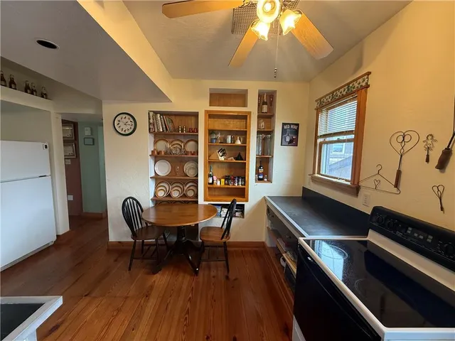 a kitchen with wooden floors and wooden cabinets
