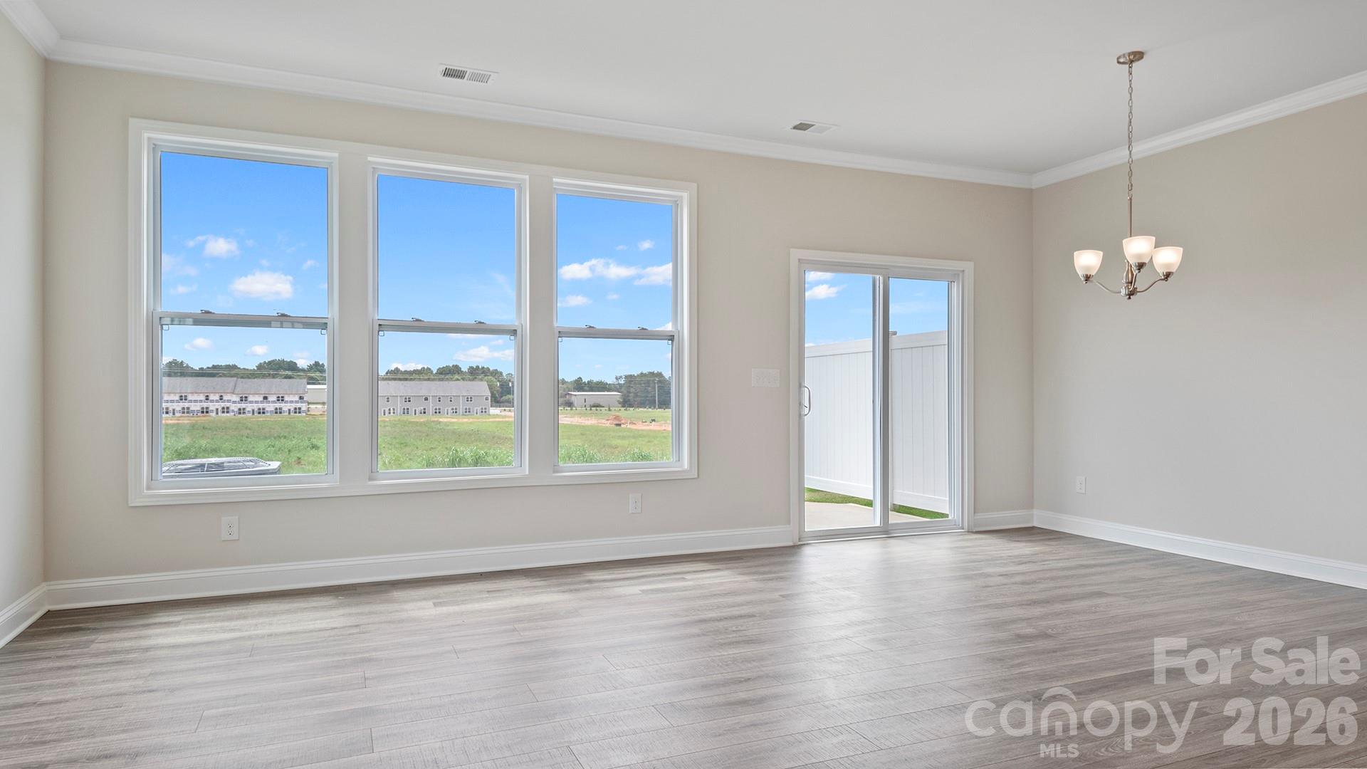 370 Lagoon Road Fletcher, NC 28732 - Photo 13 of 36 an empty room with wooden floor and windows