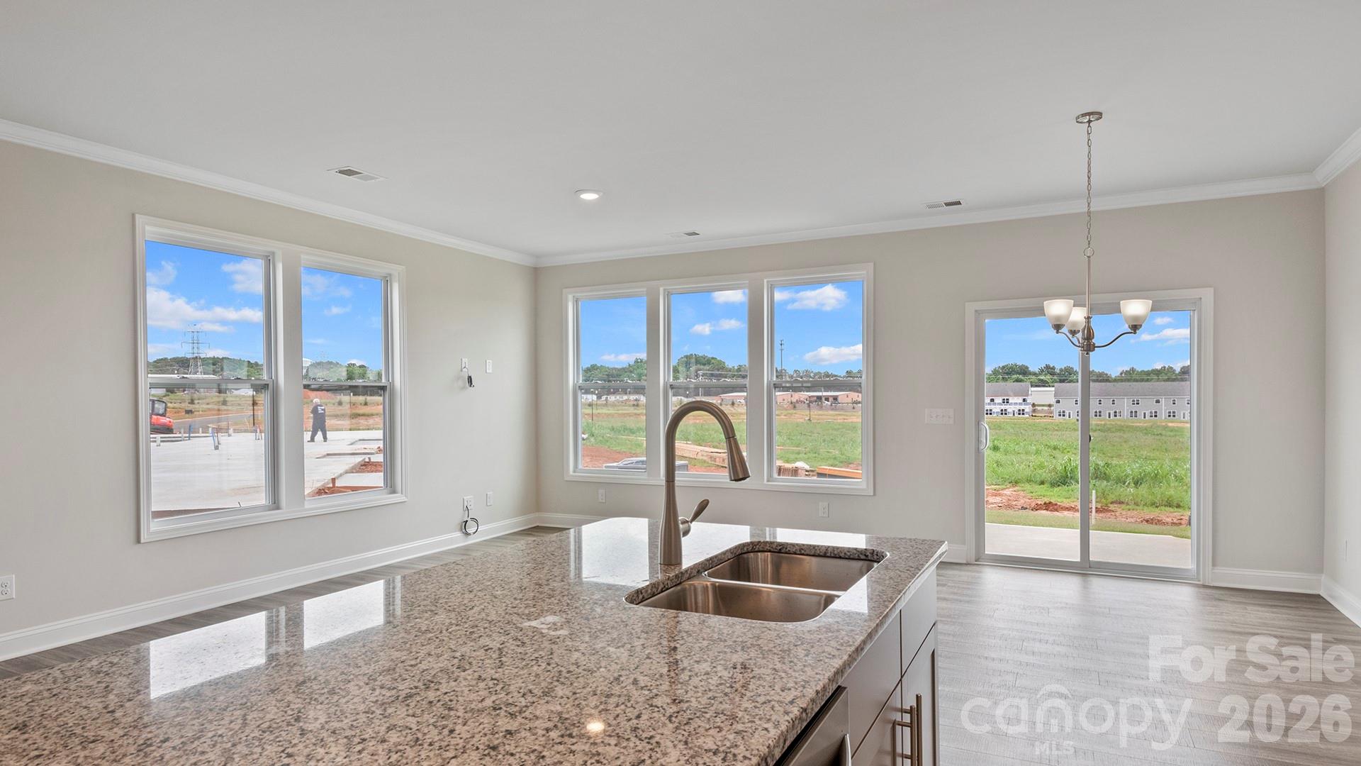 370 Lagoon Road Fletcher, NC 28732 - Photo 10 of 36 a kitchen with granite countertop a stove a sink and a wooden cabinets
