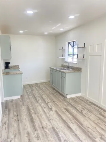 a view of kitchen with cabinets and wooden floor