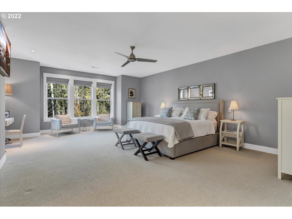 3620 Southwest 64th Place Portland, OR 97221 - Photo 15 of 32 a spacious bedroom with a bed a table and large window