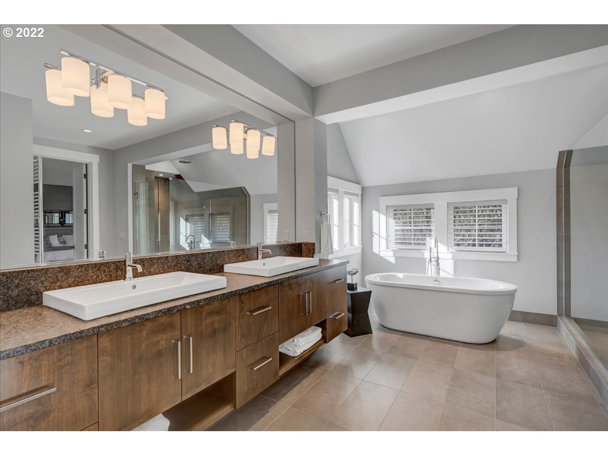 3620 Southwest 64th Place Portland, OR 97221 - Photo 17 of 32 a spacious bathroom with a granite countertop tub and a large mirror