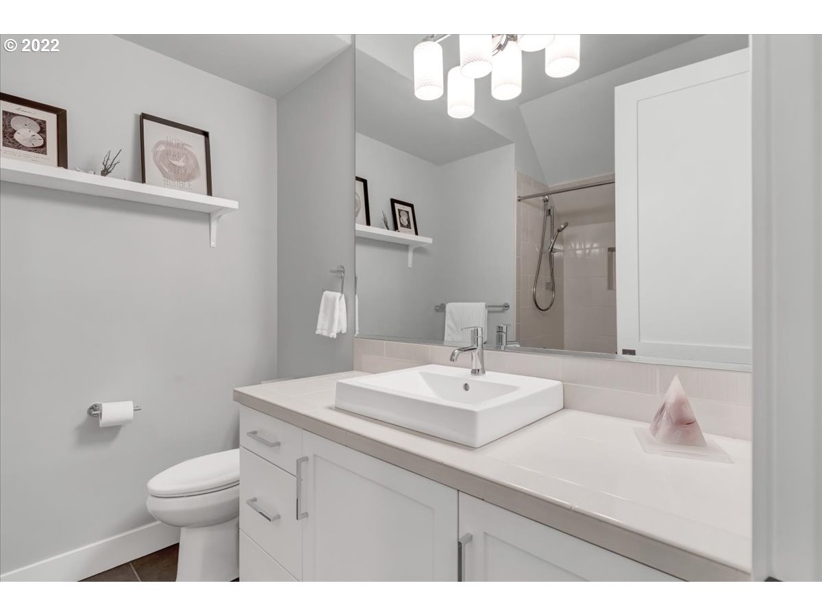 3620 Southwest 64th Place Portland, OR 97221 - Photo 22 of 32 a bathroom with a sink a mirror and a toilet