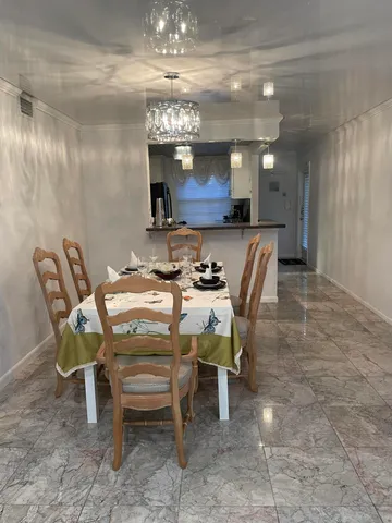 a living room with a floor to ceiling window and wooden floor