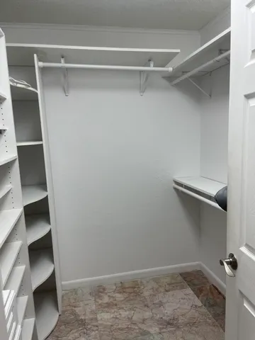 a bedroom with a bed a window and couch