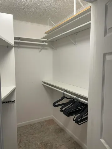 a bathroom with a granite countertop toilet sink and mirror