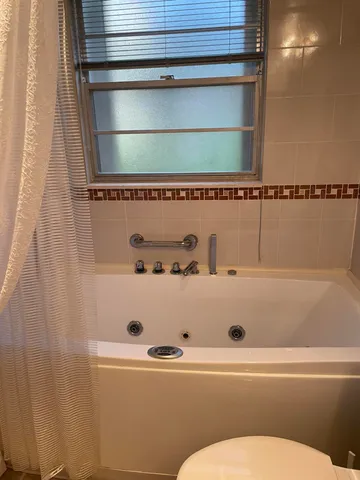 a kitchen with granite countertop a sink and a white wooden cabinets