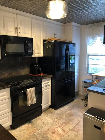 a bathroom with double vanity and a mirror