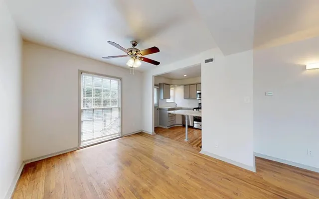 wooden floor in an empty room with a window