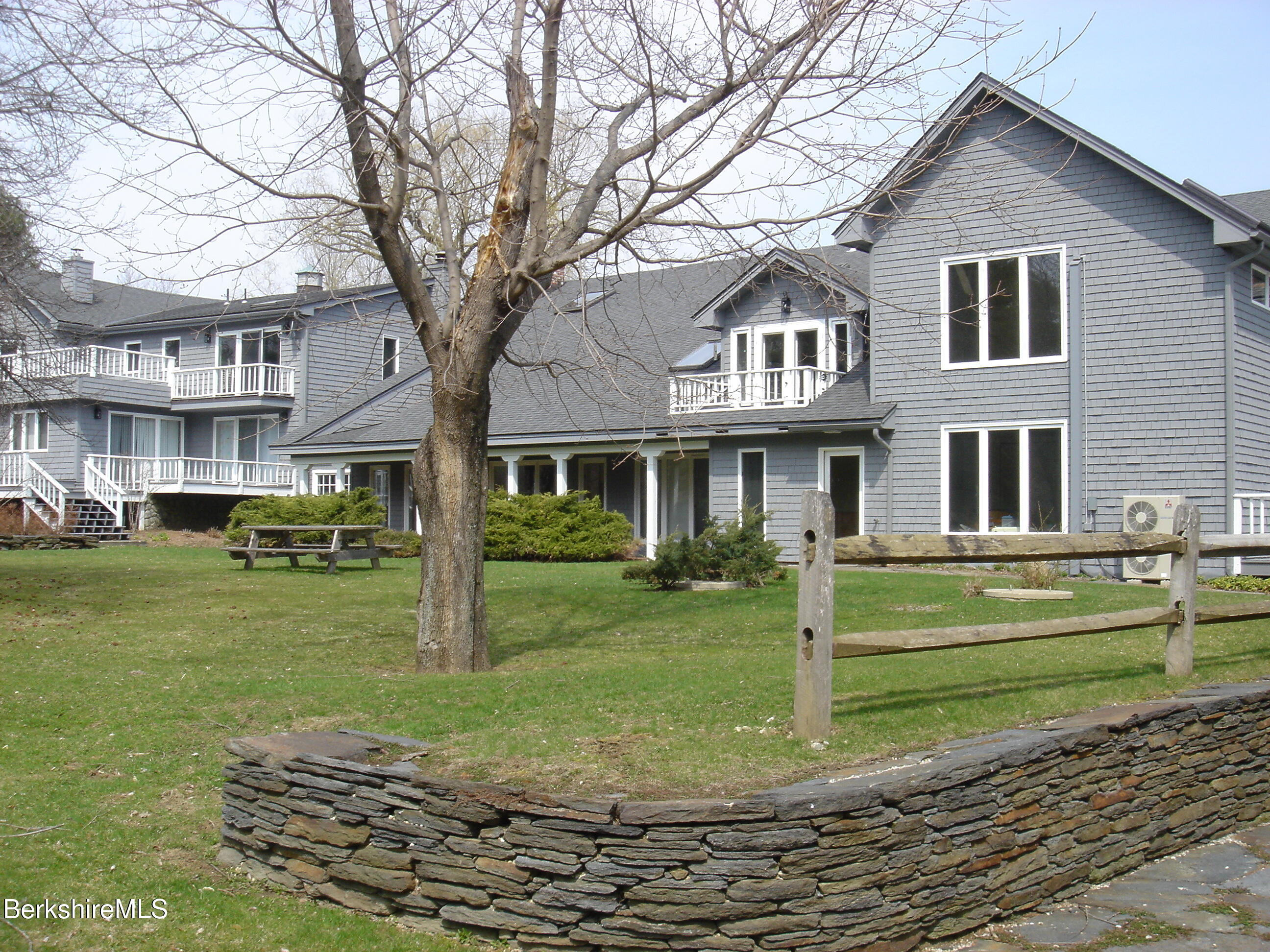 2 Wallace Road, Unit 2E Stockbridge, MA 01262 - Photo 12 of 50 a front view of a house with a yard