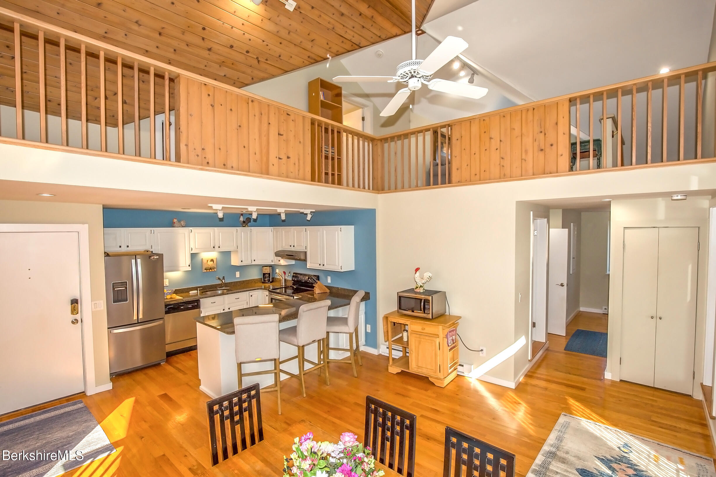 2 Wallace Road, Unit 2E Stockbridge, MA 01262 - Photo 17 of 50 a kitchen with stainless steel appliances kitchen island granite countertop a table and chairs in it