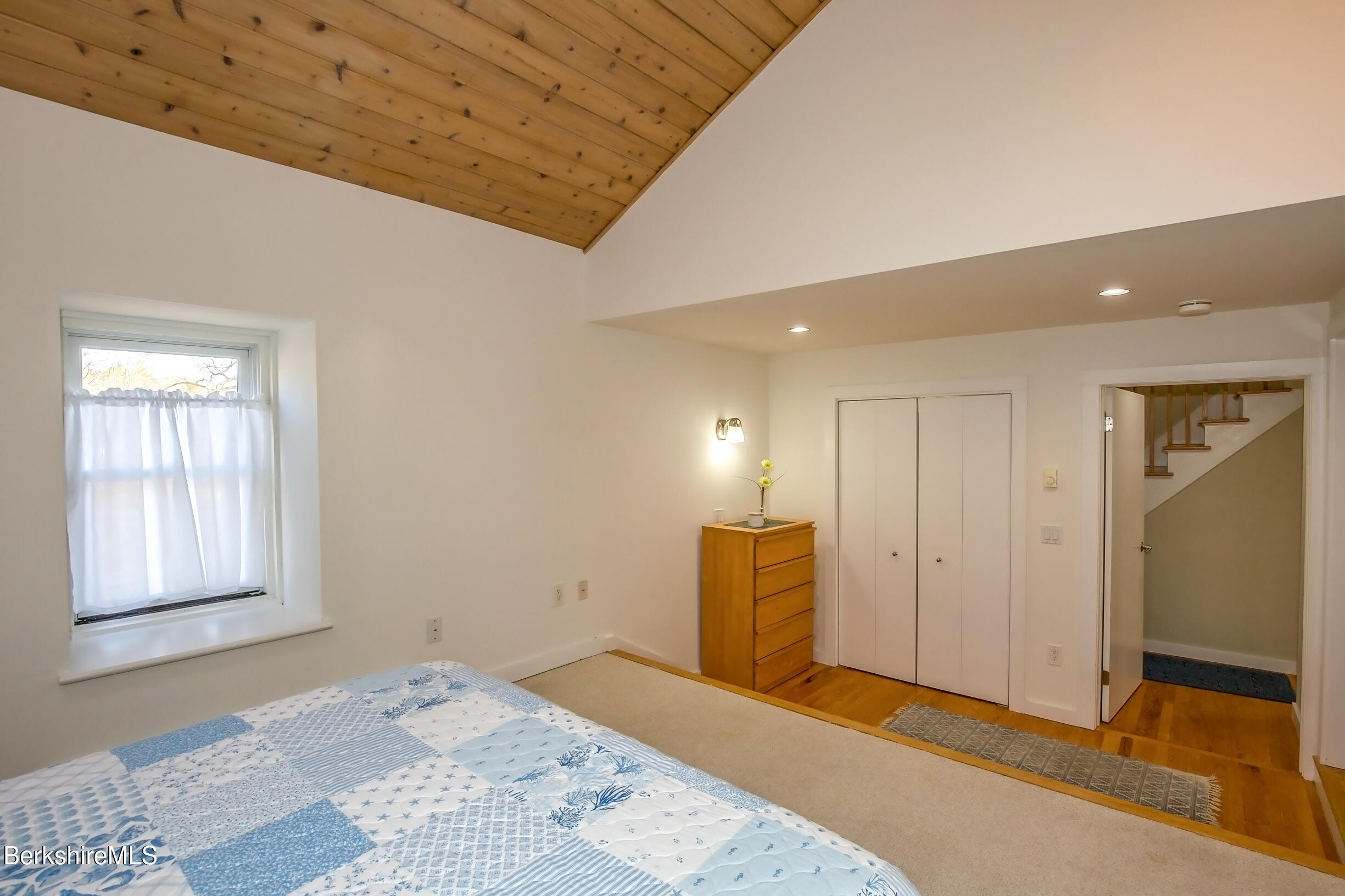 2 Wallace Road, Unit 2E Stockbridge, MA 01262 - Photo 26 of 50 a large bedroom with a bed and a window