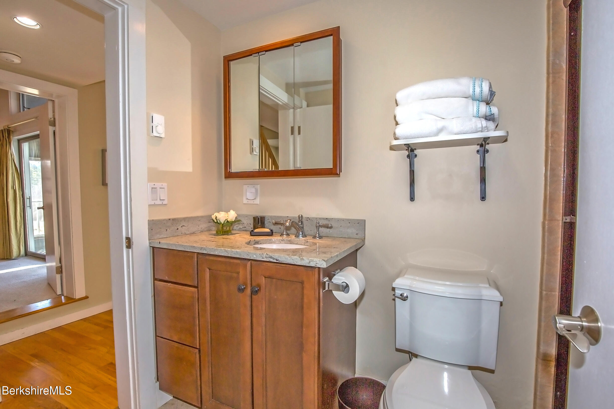2 Wallace Road, Unit 2E Stockbridge, MA 01262 - Photo 27 of 50 a bathroom with a toilet sink and mirror