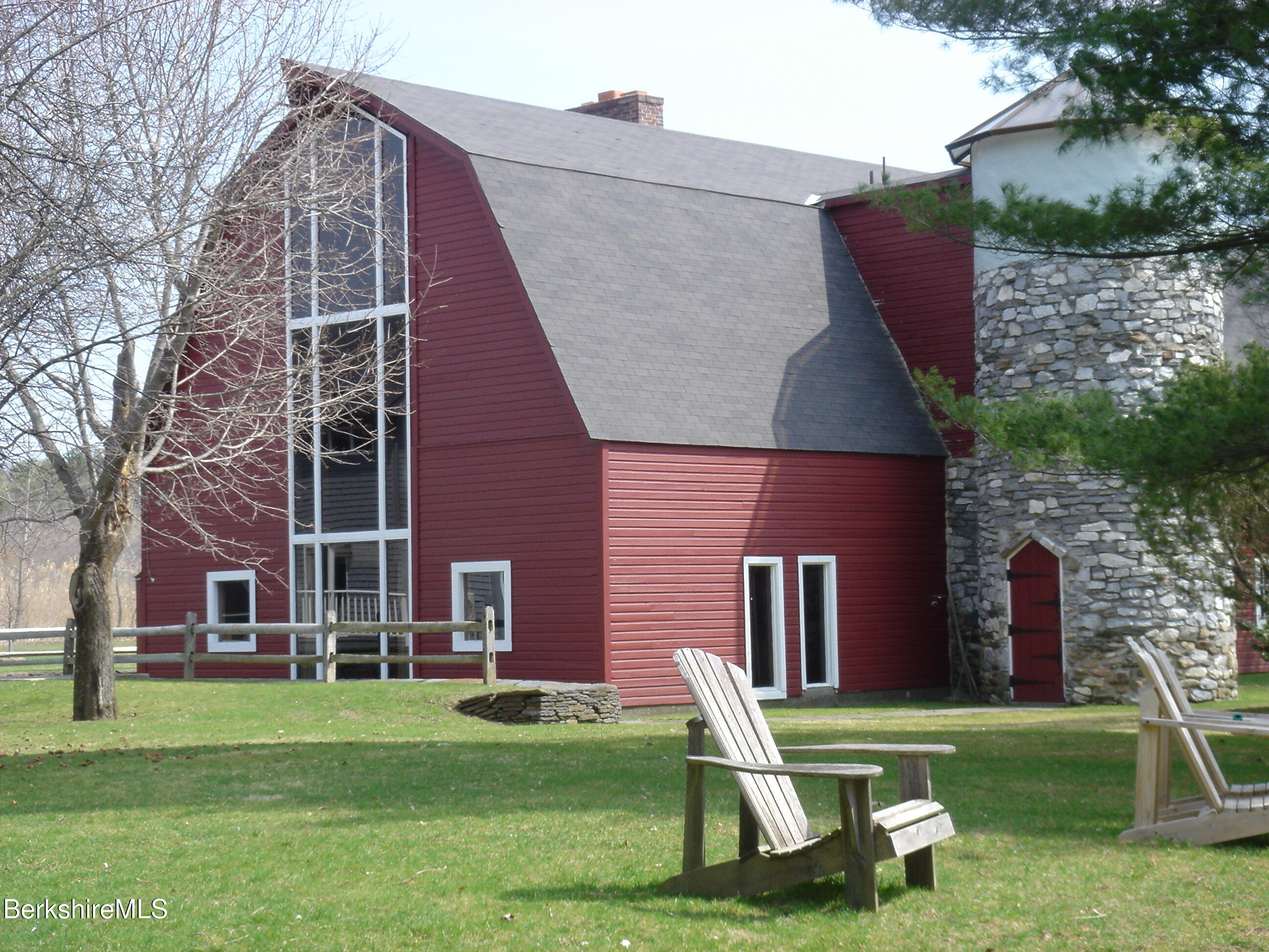 2 Wallace Road, Unit 2E Stockbridge, MA 01262 - Photo 44 of 50 a front view of a house with a garden and trees