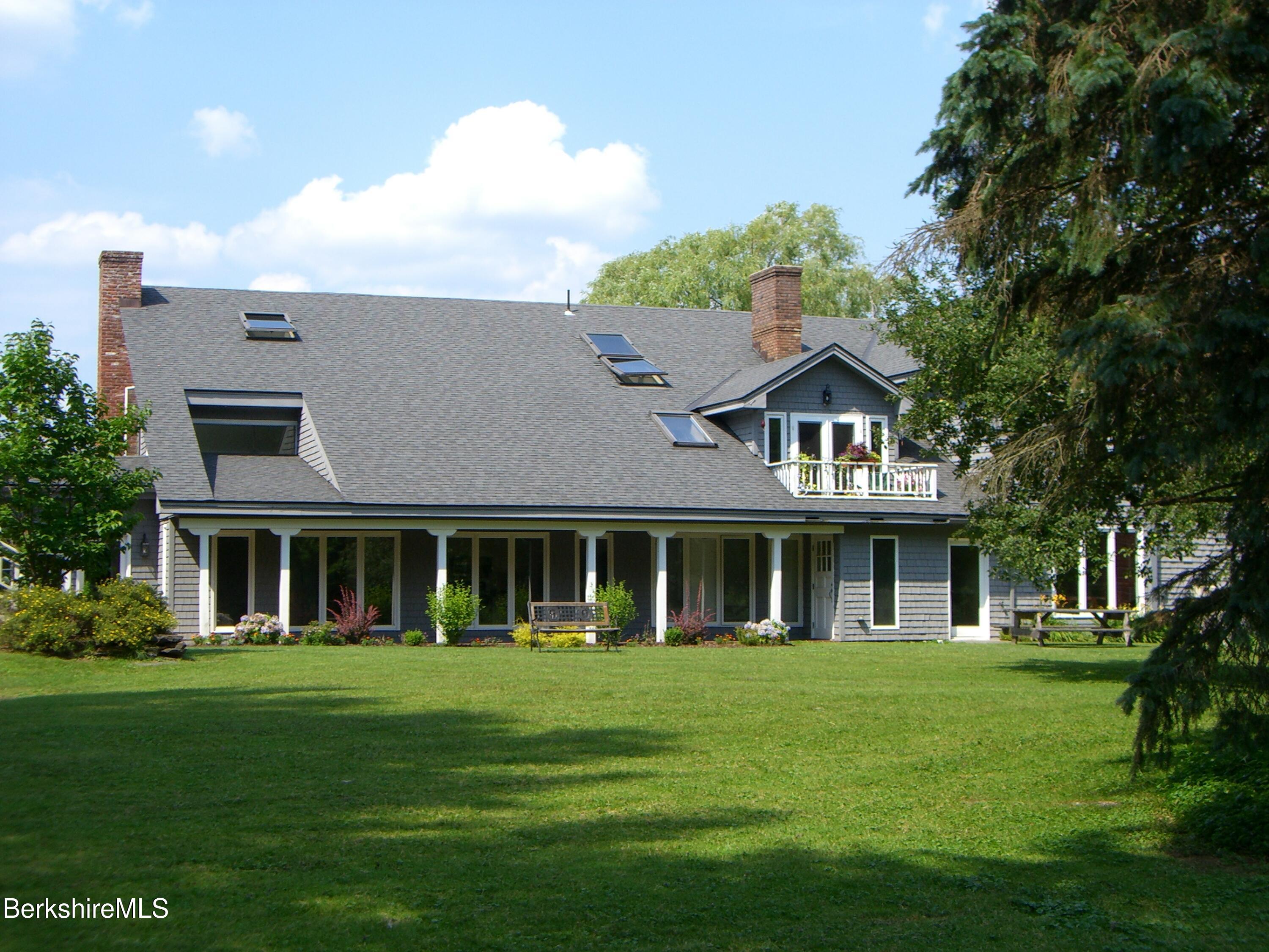 2 Wallace Road, Unit 2E Stockbridge, MA 01262 - Photo 46 of 50 a front view of a house with a garden