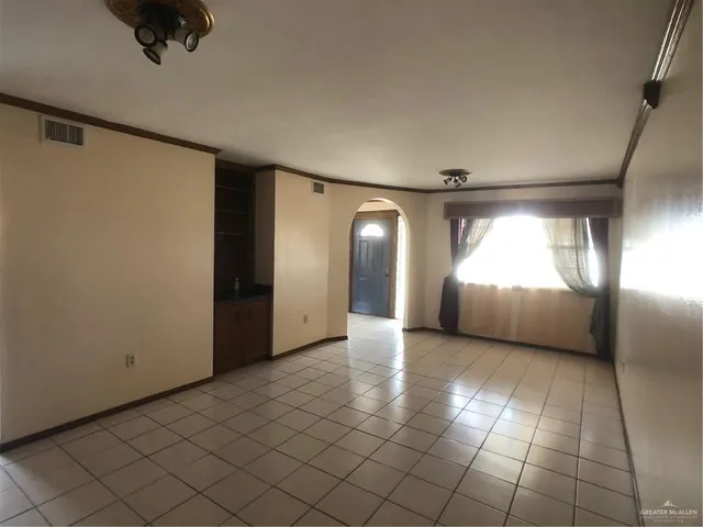 a kitchen with granite countertop a sink a stove and cabinets