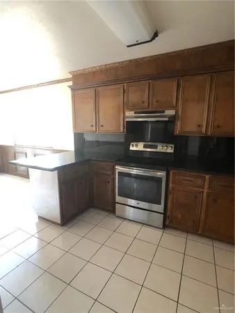 a kitchen with granite countertop a refrigerator and a stove