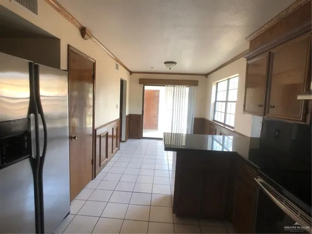a bathroom with a granite countertop sink a toilet a mirror and vanity