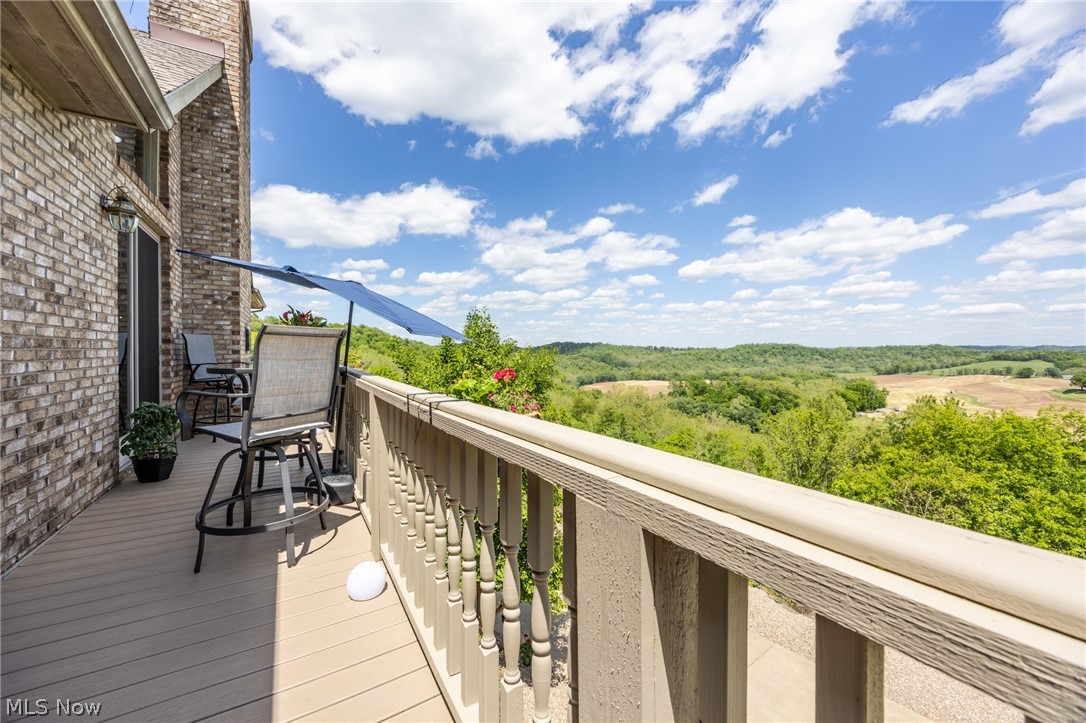 1602 Glendale Road, Unit 3 Marietta, OH 45750 - Photo 41 of 49 Expansive outdoor deck featuring composite decking, a spindle railing system, and a brick exterior facade