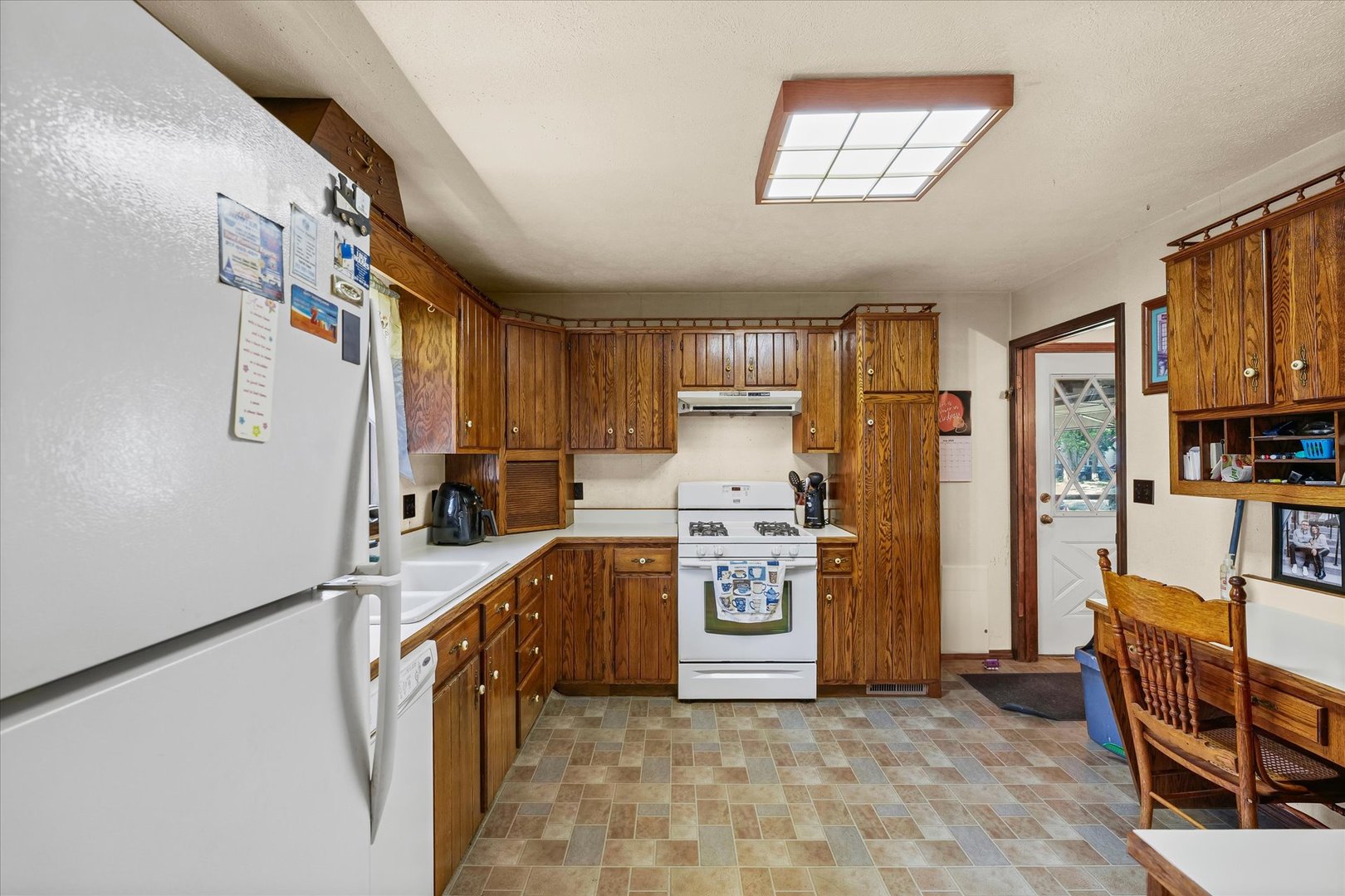 120 North Fredrick Street Rantoul, IL 61866 - Photo 14 of 46 a kitchen with a refrigerator a stove top oven and a sink