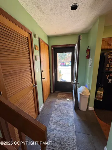 a view of a hallway with entryway and front door